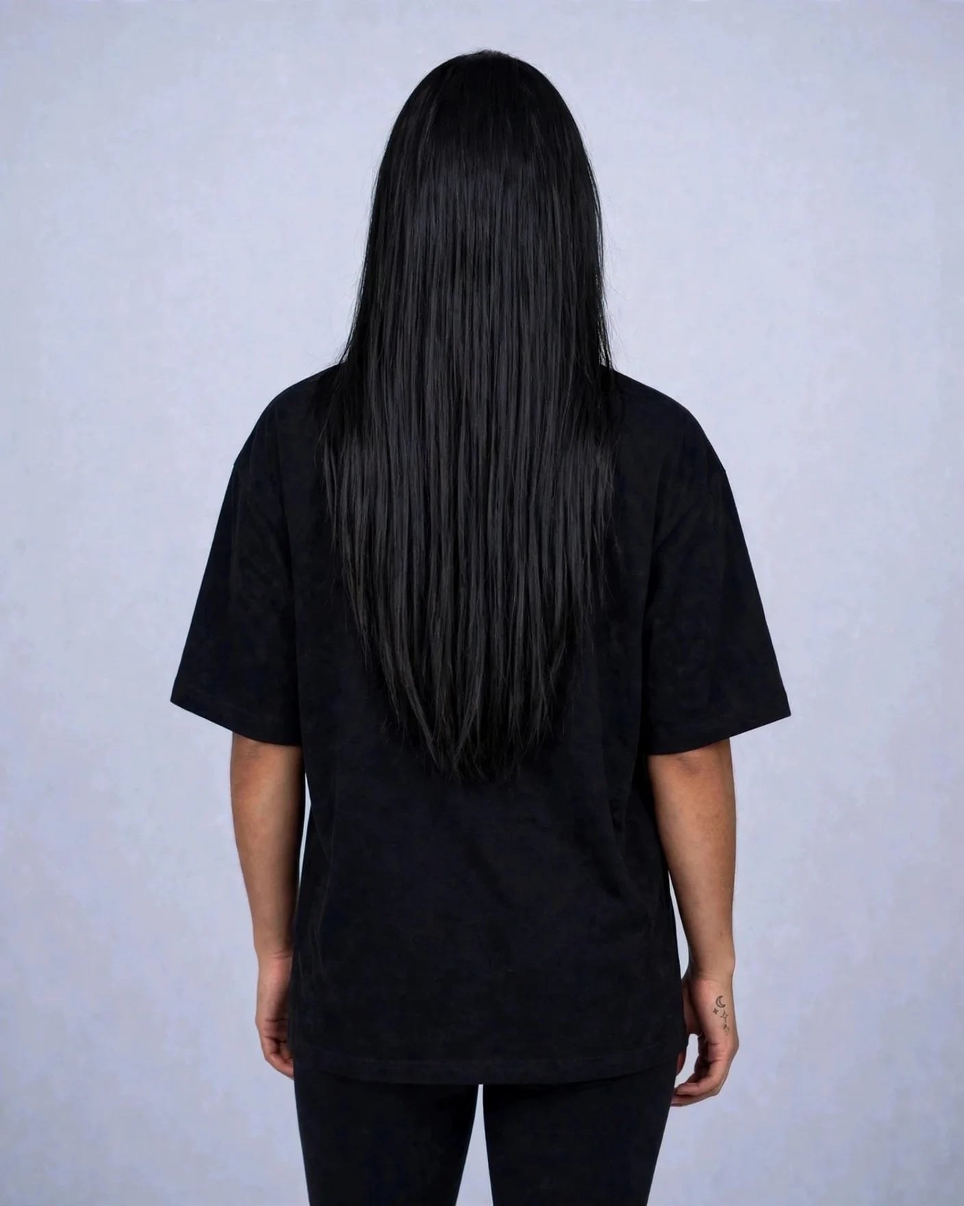 Back view of the black VEXOR metal logo tee on a woman, plain back