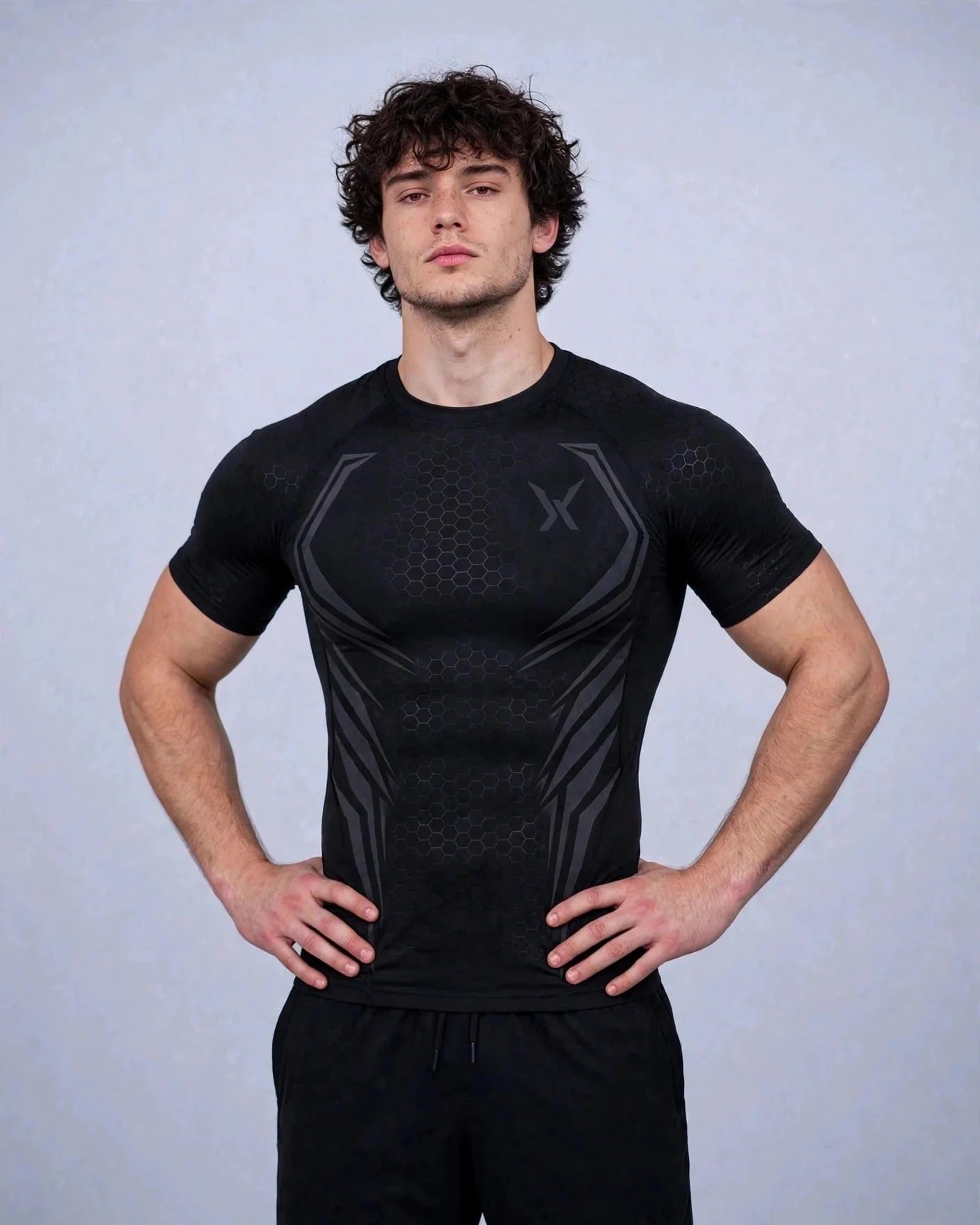 Man in the black VEXOR Hex compression tee standing with his hands on his hips